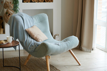 interior of a cozy room with a soft blue armchair