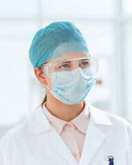 portrait of a female medical scientist in a protective mask.