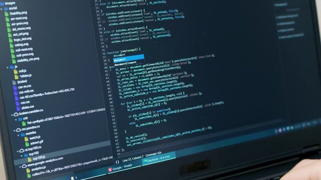 Senior Developer Debug Program, Writes Program Code. A Professional  Programmer. Close-up of the Monitor. 
