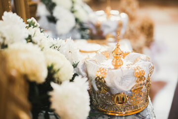 Golden crowns lying on the table in church
