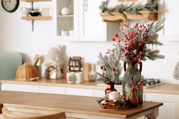 New Year's decor. Christmas trees and branches, decorations on the table, in the kitchen and at home.