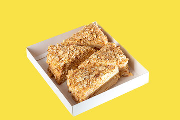 Festive puff pastry cake with custard. On a light background. Sprinkled with crumbs. Birthday, holidays, sweets.