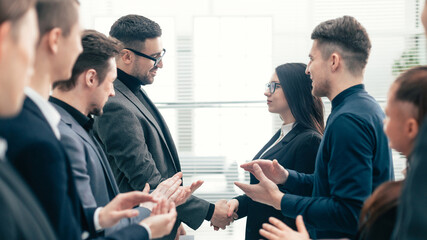 close up. two business teams applauding their leaders