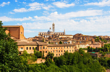 Fototapeta na wymiar Aerial view over Siena on the dome and bell tower of Siena Cathedral and the old town of the medieval city of Siena on a sunny day, Tuscany, Italy