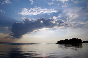 Fototapeta na wymiar Summer evening over the lake. Beautiful sky before sunset. Clouds horizon open space