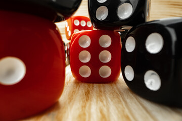 Red and black dice cubes on wooden background