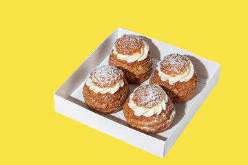 Rum baba with butter cream on a light background. Home delivery. Festive concept. Quarantine.