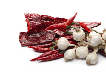 Dried spicy red peppers, paprika with garlic bulbs isolated on white background