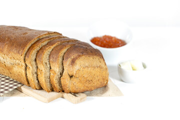 Slices of bread with red caviar on plate on white background. Top view. Copy space.