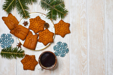 new year and christmas theme, a cup of black coffee, a warming winter drink, relaxation at home, baking snowflake-shaped cookies