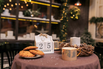 Close up Calendar with date 25 December. Coffee table with biscuit, two cups of hot coffee and...