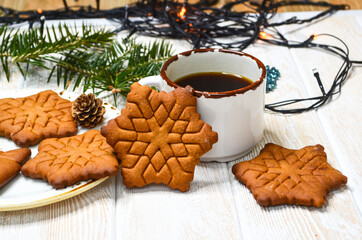 New Year's atmosphere, Christmas mood and coziness, warming winter coffee drink, relaxation at home on holiday, snowflake-shaped cookies, holiday baked goods
