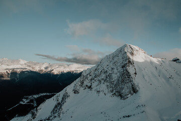 Fototapeta na wymiar Rosa Khutor. High mountain, above the clouds. Snow-capped mountain top.