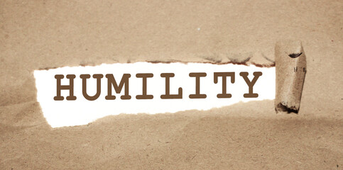 Torn pieces of paper with words Humility. Lifestyle concept