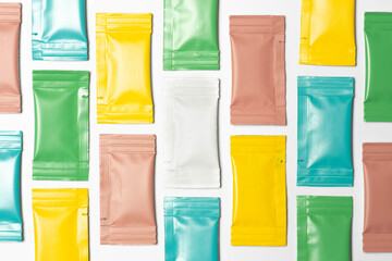 Close-up composition of colored sachets on a white background.