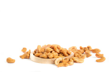isoloated roasted cashew nuts in wooden plate