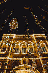 Golden blurry Christmas and New year lights of the evening city
