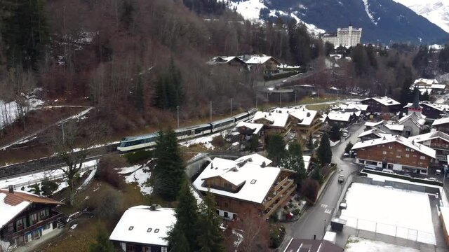 Train arriving in the beautiful village of Gstaad, Switzerland. 