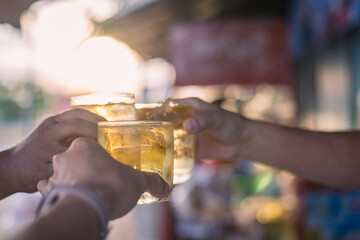 Cheers clinking of friends with whisky drink in party evening after work