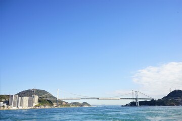Naklejka premium Kanmon Bridge from Kanmon line ferry in Shimonoseki, Fukuoka, Kitakyushu, Japan - 北九州 福岡 下関 関門橋 