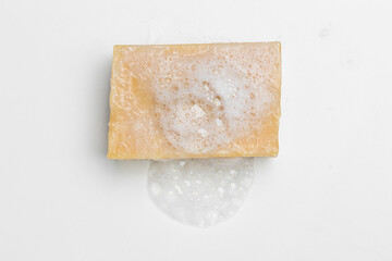 Soap bar and foam on white background, top view. Mockup for design