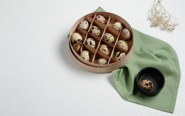quail eggs in round box with separate cells on light background. Preparing for Easter.
