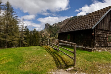 house with a wooden fence in the green nature while hiking in the spring