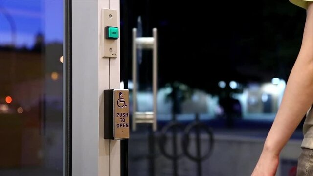 Woman pressing handicap button before leaving the apartment