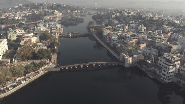 Top view of Daiji Bridge and Chand Pole Bridge crossing Lake Pichola in Udaipur, Rajasthan, India - Aerial Panoramic shot