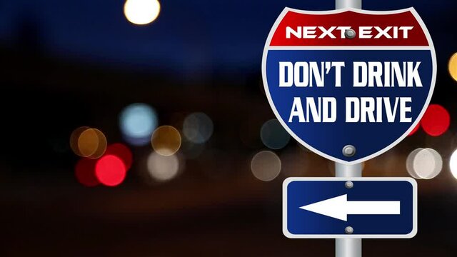 Don't drink and drive road sign with defocused night traffic lights