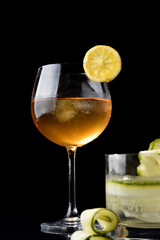 drinks in glass and glass with lemon, red berries and strawberries with shaker in elegant background
