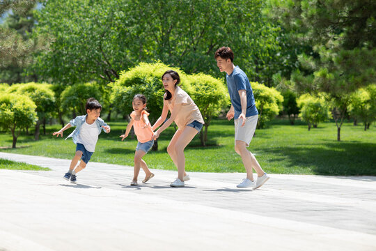 Happy young family having fun in park