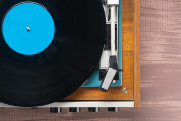equipment for listening to vinyl records on a brown table, top view