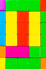 Colorful puzzle cubes background, geometric figures, table game
