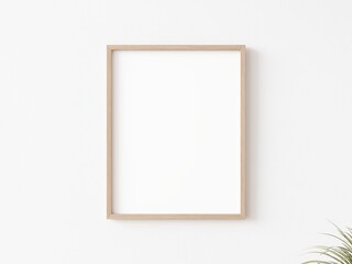 Single empty vertically oriented rectangular picture frame with thin wooden border hanging on white wall. 3D illustration.