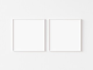 Two blank square picture frames with thin white border hanging on white wall. 3D illustration.