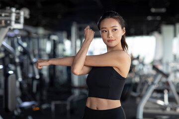 Young woman stretching at gym