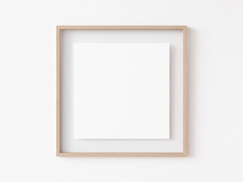 Empty square light wood picture frame with white center hanging on white wall. 3D Illustration.