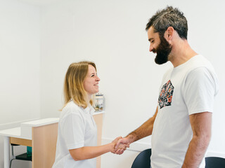 The physiotherapist gives the patient a handshake once the treatment is over.