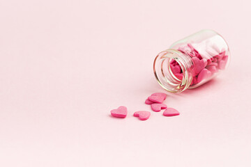 Sweets - hearts in small glass bottles. Colorful Valentines Day heart shaped candy with copy space. Sainte Valentine, mother's day greeting cards, invitation.