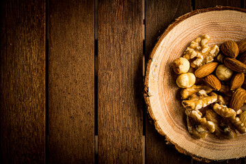 mix of almonds, walnuts and hazelnuts on a wooden table