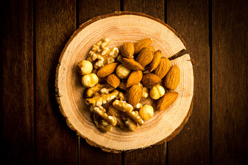 mix of almonds, walnuts and hazelnuts on a wooden table