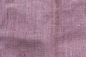 Fototapeta premium The texture of an uneven crumpled, roughly woven burlap.