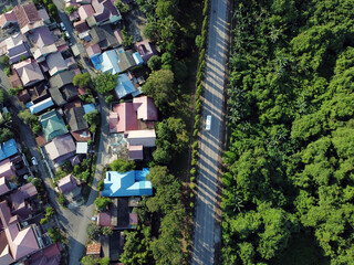 Neighborhood in green forest park aerial above top view. Location: East Kutai, East Kalimantan/Indonesia