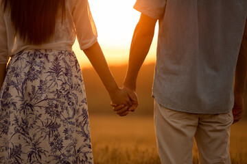 Happy young couple having fun in wheat field