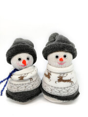 Isolated funny snowmen sewn from socks on a white background. New Year's gifts