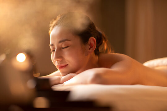 Beautiful young woman relaxing on massage table