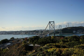 View of Kanmon Bridge and sea from above with red foliage in Shimonoseki, Fukuoka, Kitakyushu, Japan - 北九州 下関 関門橋