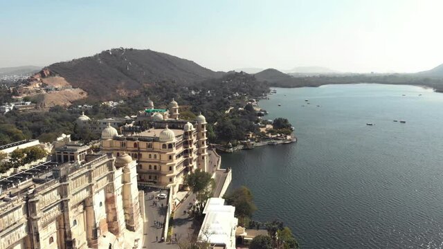 View of Taj Fateh Prakash Palace near Lake Pichola in Udaipur, Rajasthan, India - Aerial Fly-over shot