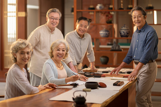 Happy friends practicing calligraphy together